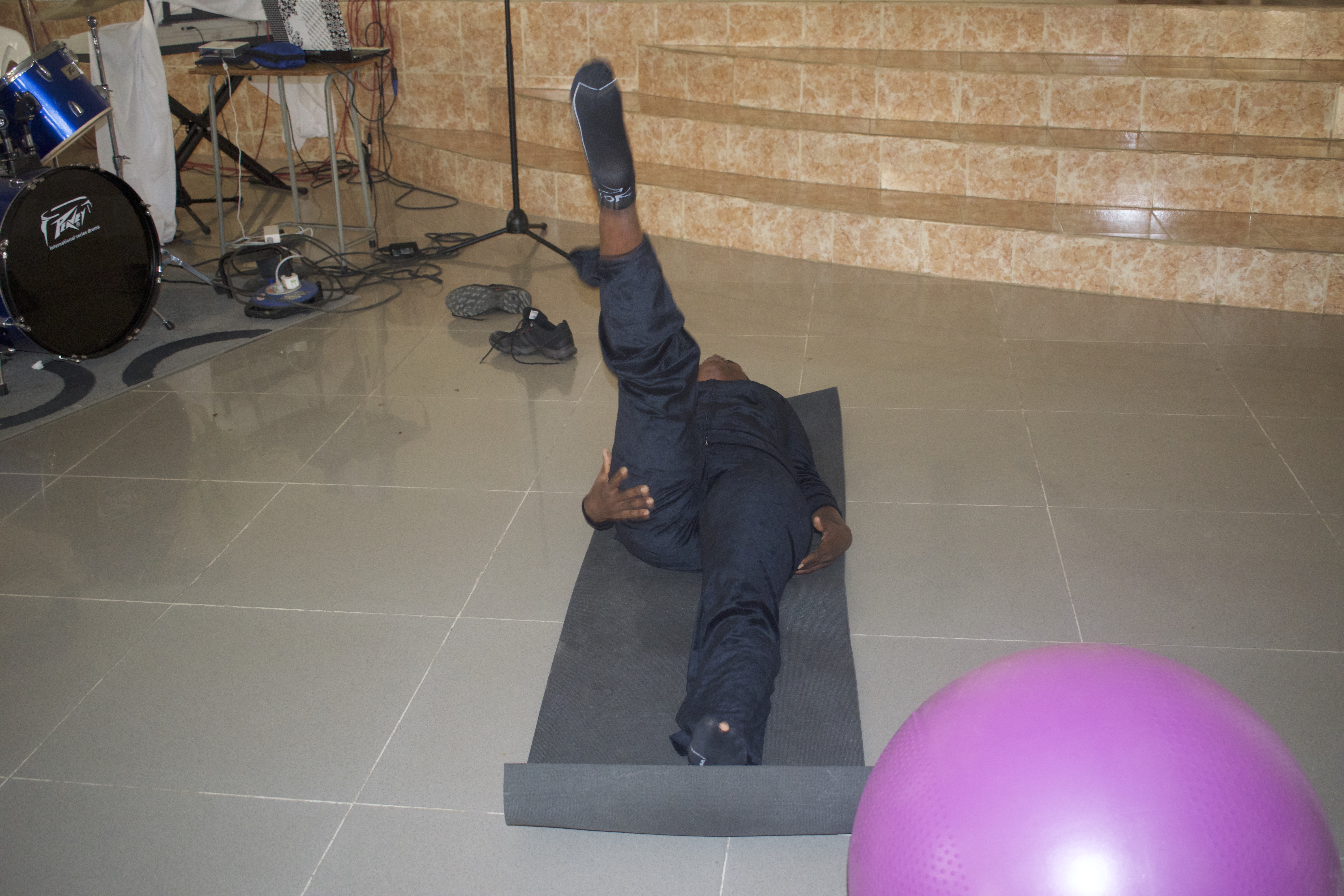 A volunteer middle-aged woman demonstrating aerobic physical exercises